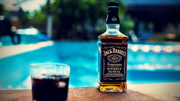 A bottle of Jack Daniels, poolside, at Lyons Holiday Parks