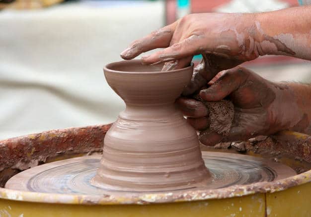 A potter throwing a pot.